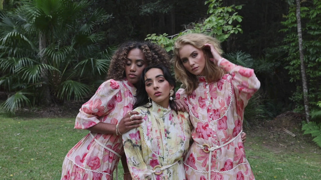 3 women wearing romantic styled dresses, with gathered lace detailed tiers, blouson sleeves and a pleated bodice by Analia the label